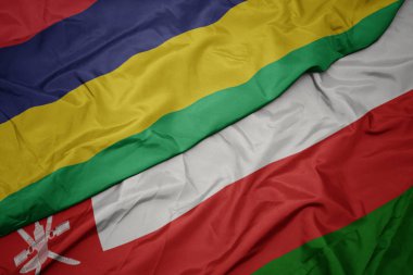umman renkli bayrak ve mauritius ulusal bayrak sallayarak.