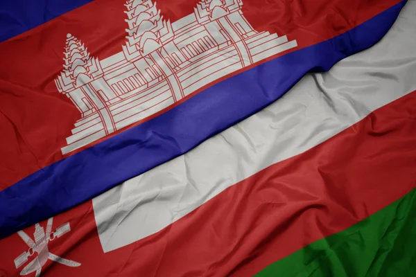 Acenando bandeira colorida de oman e bandeira nacional de cambodia . — Fotografia de Stock