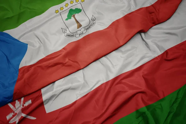 Ondeando colorida bandera de Omán y bandera nacional de Guinea Ecuatorial . —  Fotos de Stock