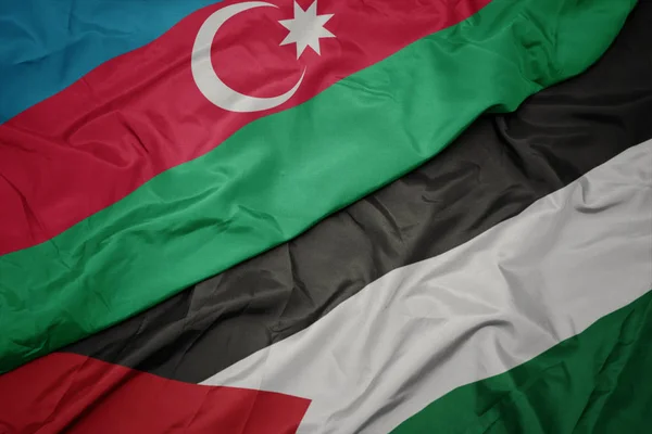 waving colorful flag of palestine and national flag of azerbaijan.