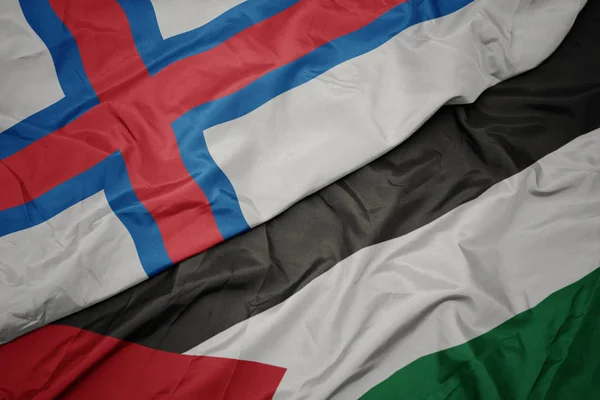 waving colorful flag of palestine and national flag of faroe islands.