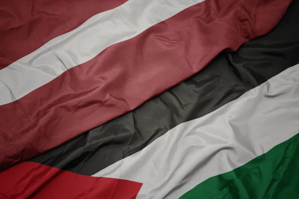 Palesztina és Lettország nemzeti zászlója színpompás zászlaja. — Stock Fotó