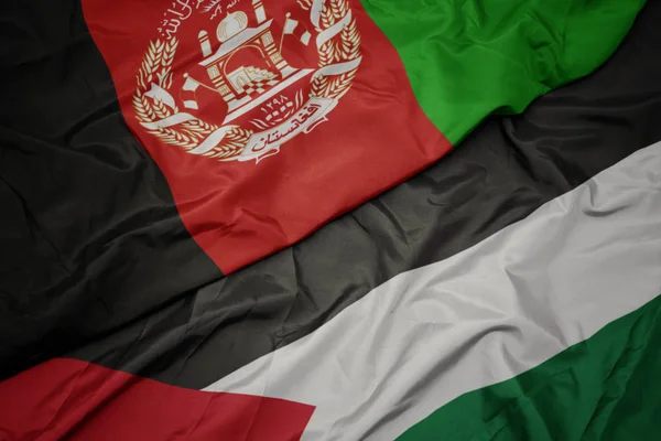 Ondeando colorida bandera de Palestina y bandera nacional de Afganistán . — Foto de Stock