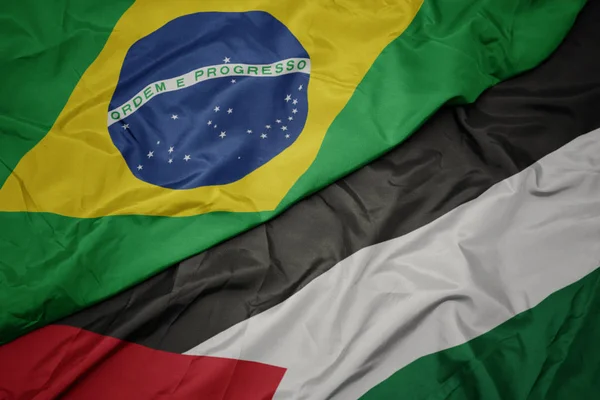 waving colorful flag of palestine and national flag of brazil.