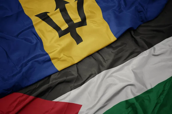 waving colorful flag of palestine and national flag of barbados.