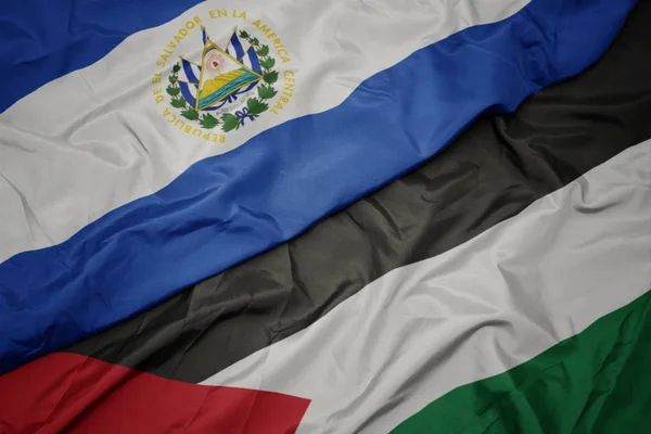 waving colorful flag of palestine and national flag of el salvador.