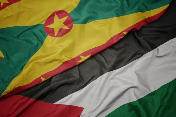 waving colorful flag of palestine and national flag of grenada.