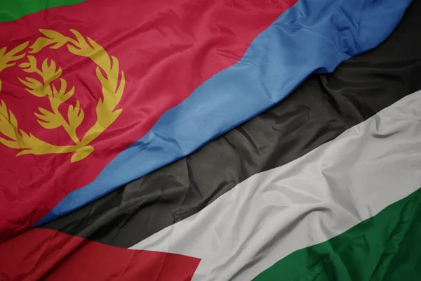waving colorful flag of palestine and national flag of eritrea.