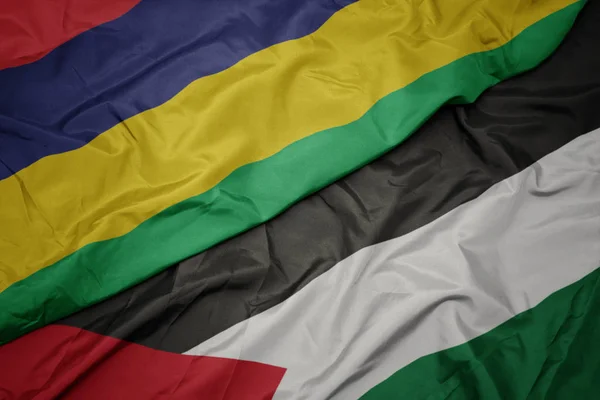 waving colorful flag of palestine and national flag of mauritius.