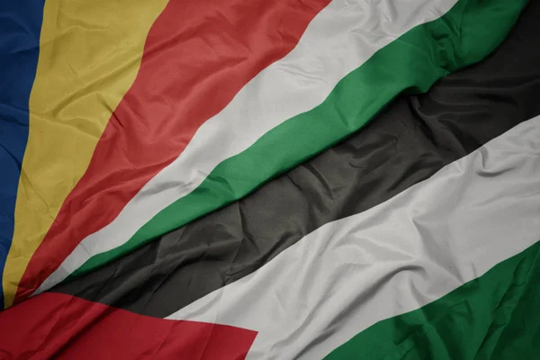 waving colorful flag of palestine and national flag of seychelles.