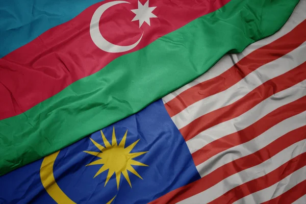 マレーシアのカラフルな旗とアゼルバイジャンの国旗を振る. — ストック写真