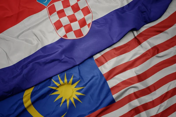 Viftande färgglada flagga av Malaysia och nationella flaggan i Kroatien. — Stockfoto