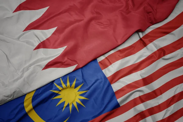 マレーシアのカラフルな旗とバーレーンの国旗を振る. — ストック写真