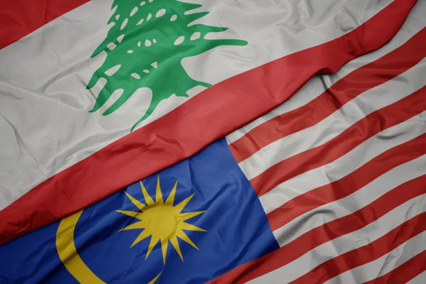Waving colorful flag of malaysia and national flag of lebanon. — Stock Photo, Image