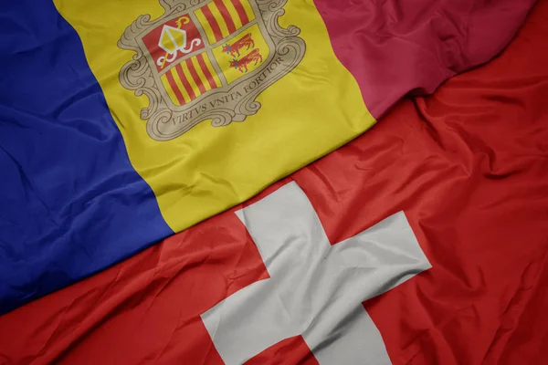 Vifta färgglada flagga Schweiz och nationella flaggan i Andorra. — Stockfoto
