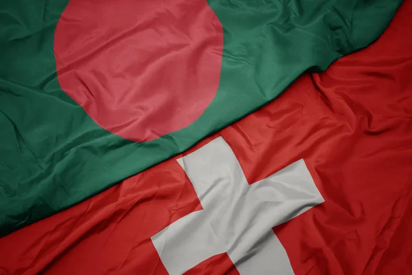 A svájci zászló színes zászlója és Banglades nemzeti zászlaja. — Stock Fotó