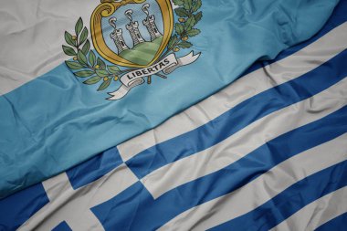 yunanistan ve san marino ulusal bayrağı renkli bayrak sallayarak.