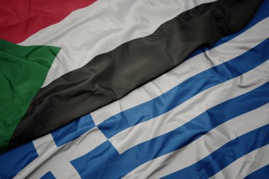 yunanistan ve sudan ulusal bayrağı renkli bayrak sallayarak.