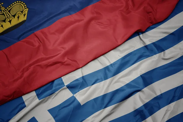 Ondeando colorida bandera de Grecia y bandera nacional de Liechtenstein . — Foto de Stock