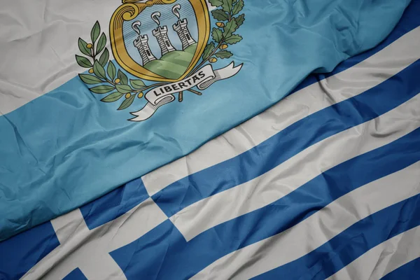 yunanistan ve san marino ulusal bayrağı renkli bayrak sallayarak.