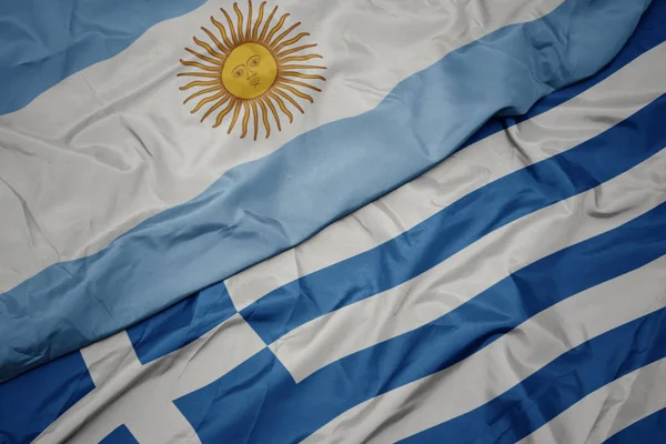 Waving colorful flag of greece and national flag of argentina. — Stock Photo, Image