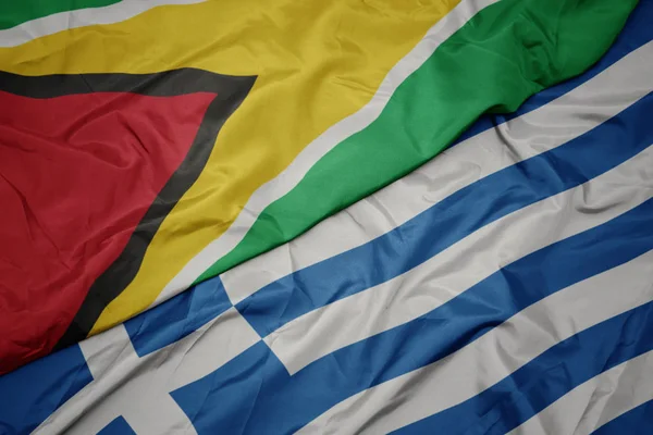 yunanistan ve guyana ulusal bayrağı renkli bayrak sallayarak.