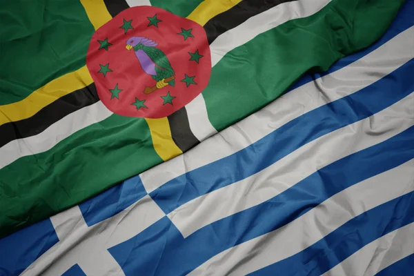 Acenando bandeira colorida da grécia e bandeira nacional da dominica . — Fotografia de Stock