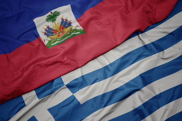 Ondeando colorida bandera de Grecia y bandera nacional de Haití . —  Fotos de Stock