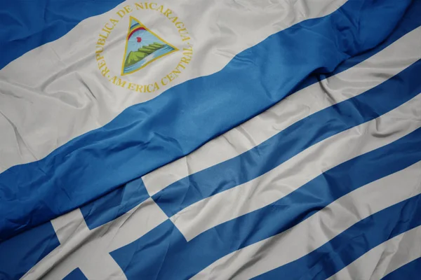 yunanistan ve nikaragua ulusal bayrağı renkli bayrak sallayarak.