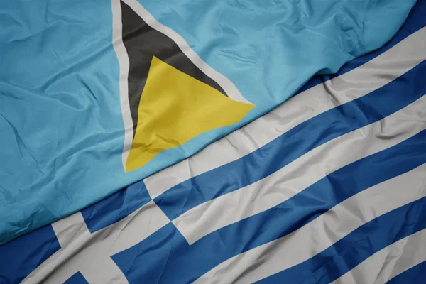 Acenando bandeira colorida da grécia e bandeira nacional de santa Lúcia . — Fotografia de Stock