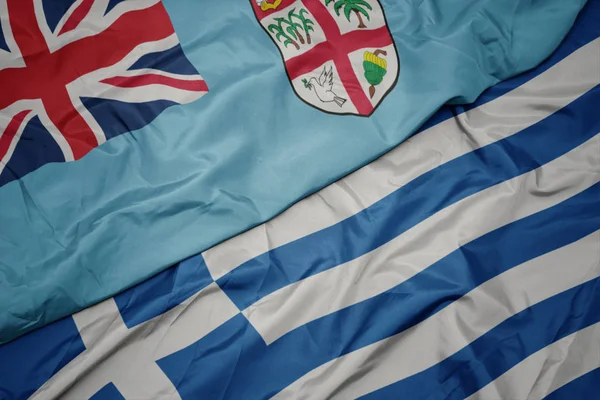 Waving colorful flag of greece and national flag of Fiji . — Stock Photo, Image