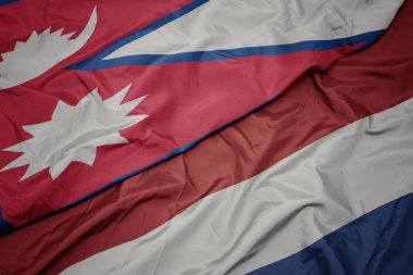 hollanda ve nepal ulusal bayrağı renkli bayrak sallayarak.