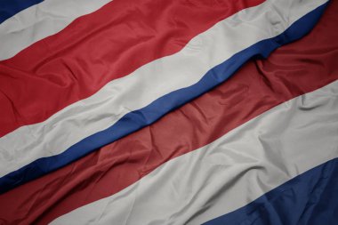 hollanda ve kosta rika ulusal bayrağı renkli bayrak sallayarak.