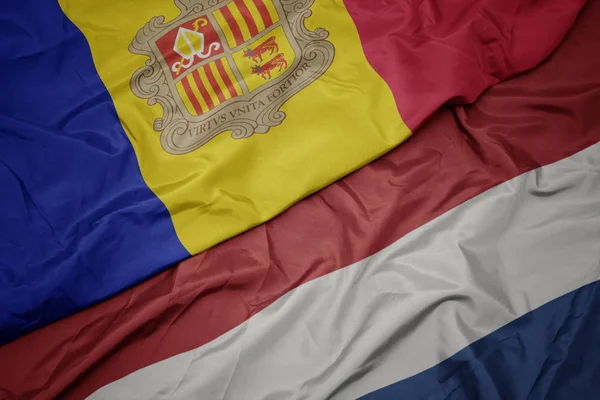 挥舞着五颜六色的荷兰国旗和安道尔国旗. — 图库照片