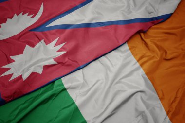 İrlanda ve nepal ulusal bayrağı renkli bayrak sallayarak.