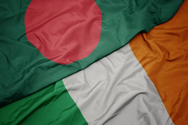 Waving colorful flag of ireland and national flag of bangladesh. — Stock Photo, Image