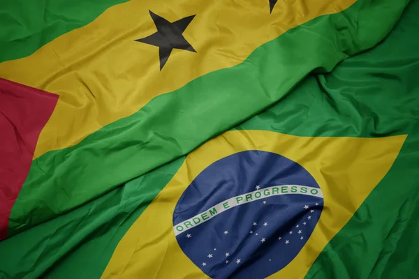 Ondeando colorida bandera de Brasil y bandera nacional de sao tome y principe  . —  Fotos de Stock