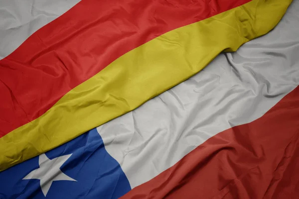 Waving colorful flag of chile and national flag of south ossetia. — Stock Photo, Image