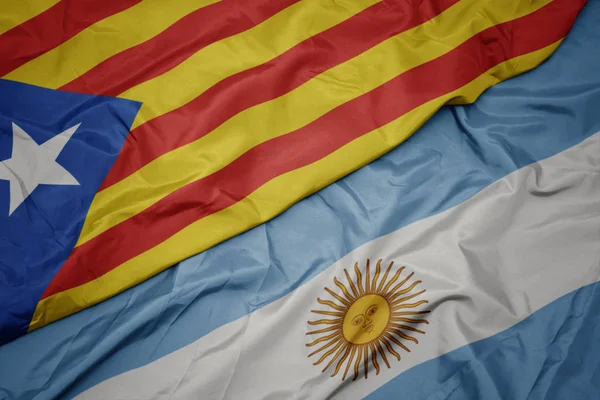 Waving colorful flag of argentina and national flag of catalonia. — Stock Photo, Image