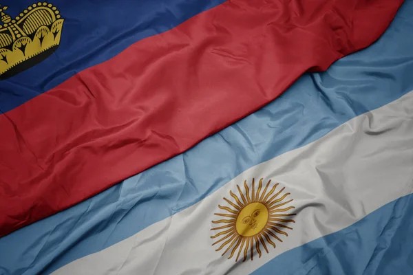 Ondeando colorida bandera de Argentina y bandera nacional de liechtenstein . —  Fotos de Stock