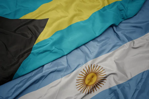 Waving colorful flag of argentina and national flag of bahamas. — Stock Photo, Image