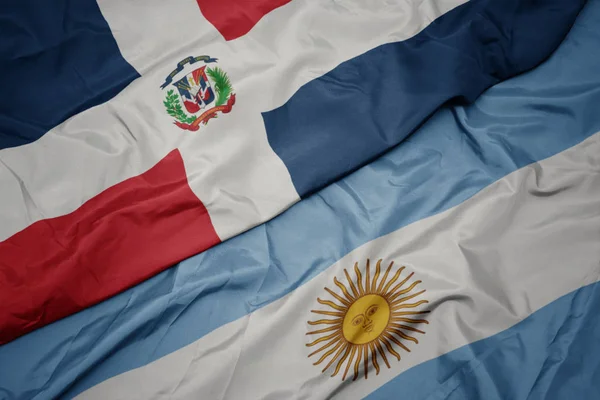 Waving colorful flag of argentina and national flag of dominican republic. — Stock Photo, Image