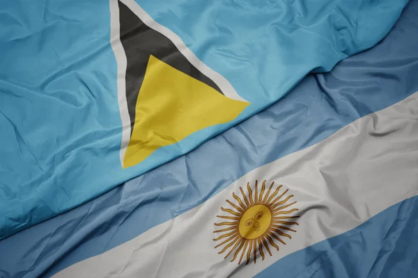 Waving colorful flag of argentina and national flag of saint lucia. — Stock Photo, Image