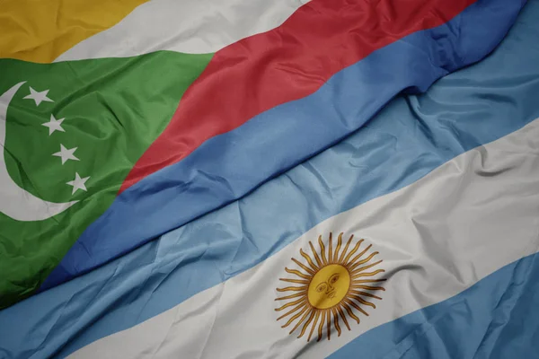Mávající barvitá vlajka Argentiny a národní vlajka komor. — Stock fotografie