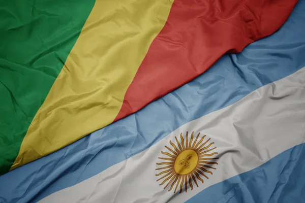 Waving colorful flag of argentina and national flag of republic of the congo. — Stock Photo, Image