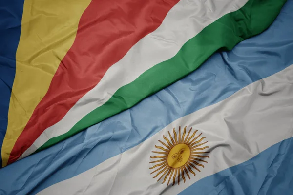Waving colorful flag of argentina and national flag of seychelles. — Stock Photo, Image