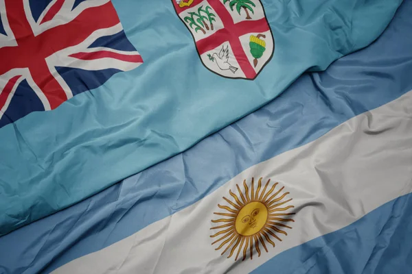 Ondeando colorida bandera de Argentina y bandera nacional de Fiyi  . —  Fotos de Stock