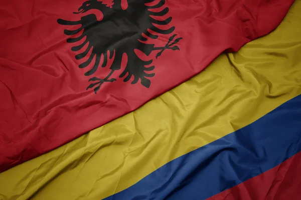 Waving colorful flag of colombia and national flag of albania. — Stock Photo, Image