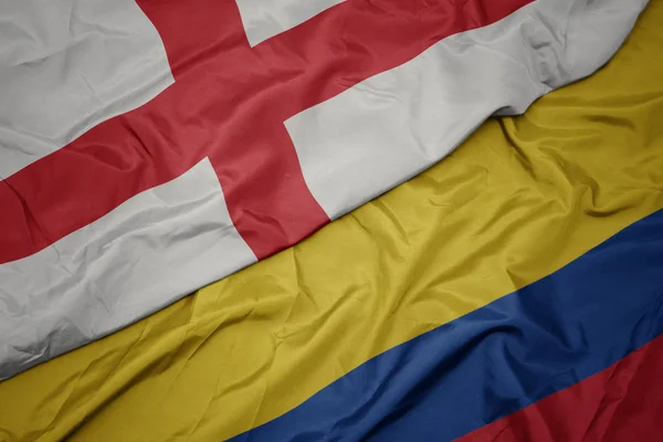 Waving colorful flag of colombia and national flag of england. — Stock Photo, Image