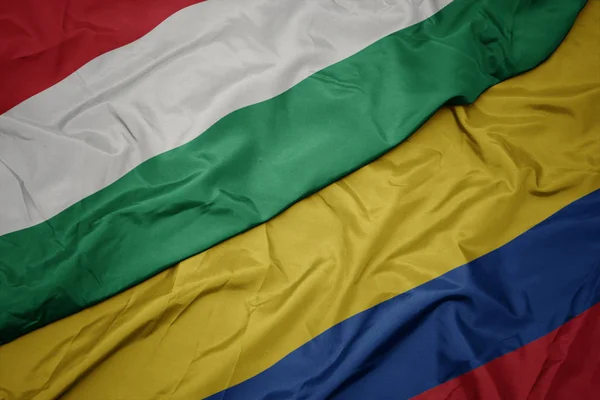 Kolombiya ve macaristan ulusal bayrağı renkli bayrak sallayarak. — Stok fotoğraf